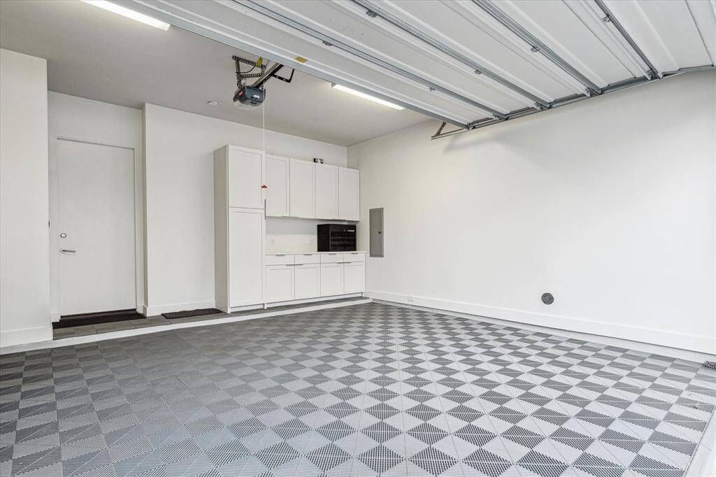 Garage features Swisstrax System Tile Flooring . Built in storage cabinets.
