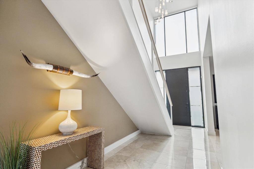 Floating staircase is featured in the entry hall.