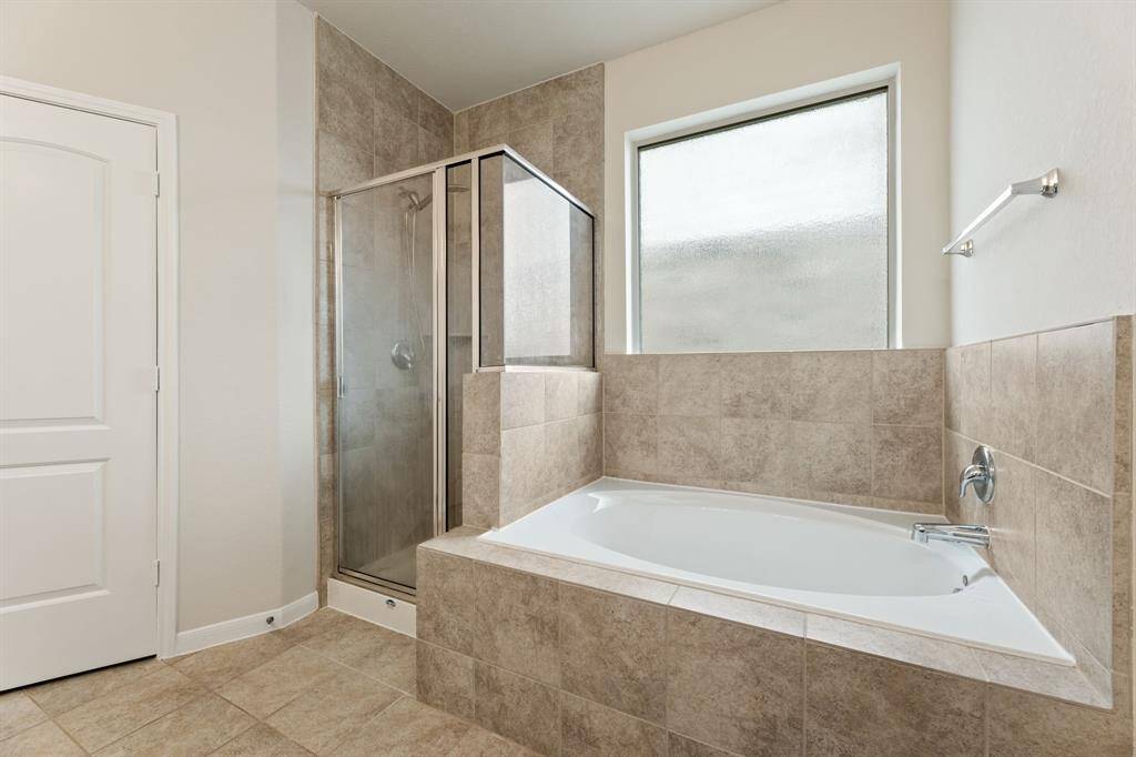 The bathroom features a linen closet, a separate tub, shower, and toilet room for privacy.