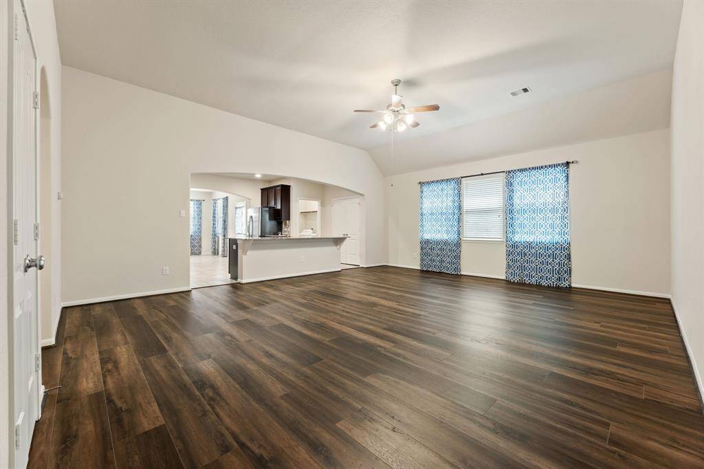 This large Living room is as grand as it looks, and features LVP flooring.