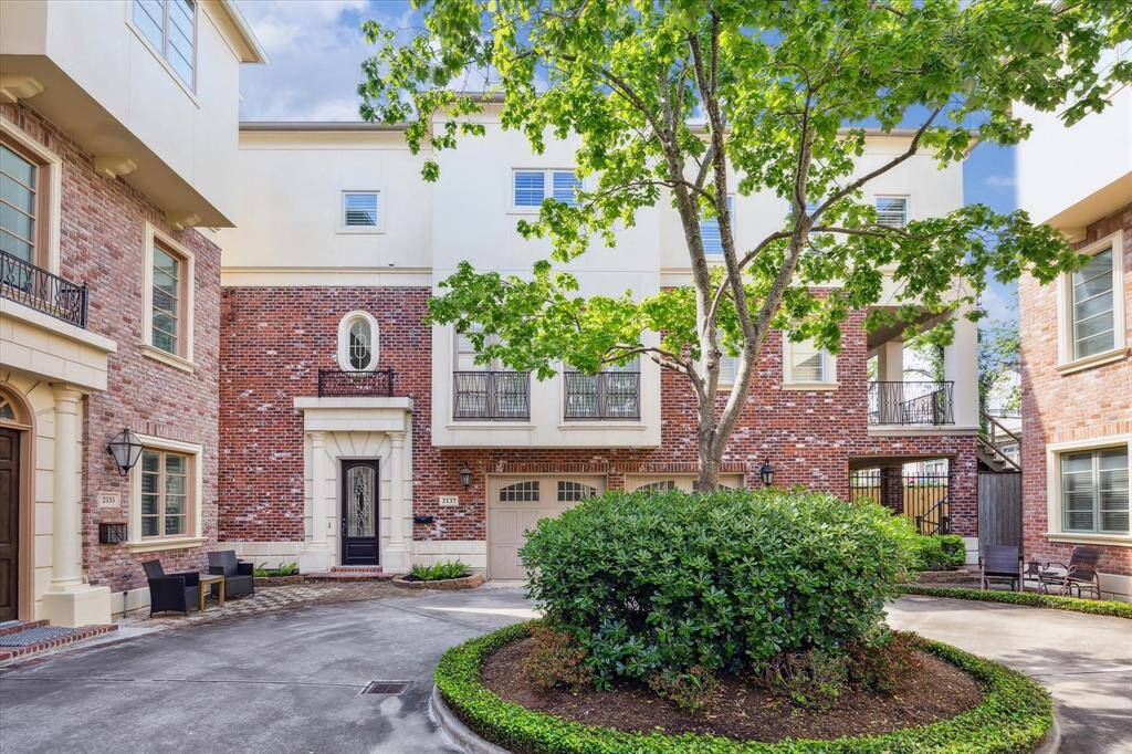 The facade of this stately 3 bed/3.5 bath Georgian home is enhanced by elegant wrought iron detailing.