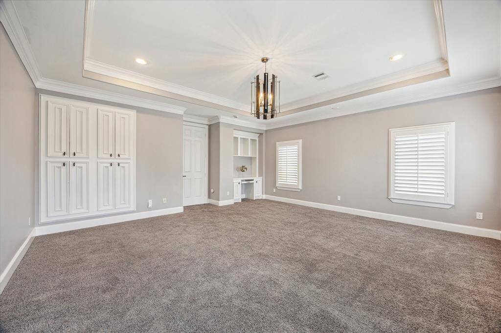 Custom built-ins flank the French doors.