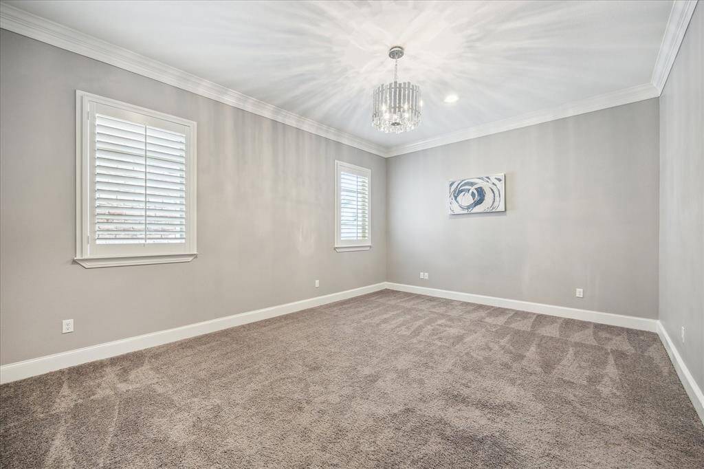 The first-floor covered patio offers a relaxing retreat with stylish tiled floors and a ceiling fan to keep you cool on warm days. It overlooks the backyard, creating a perfect spot to unwind or entertain.