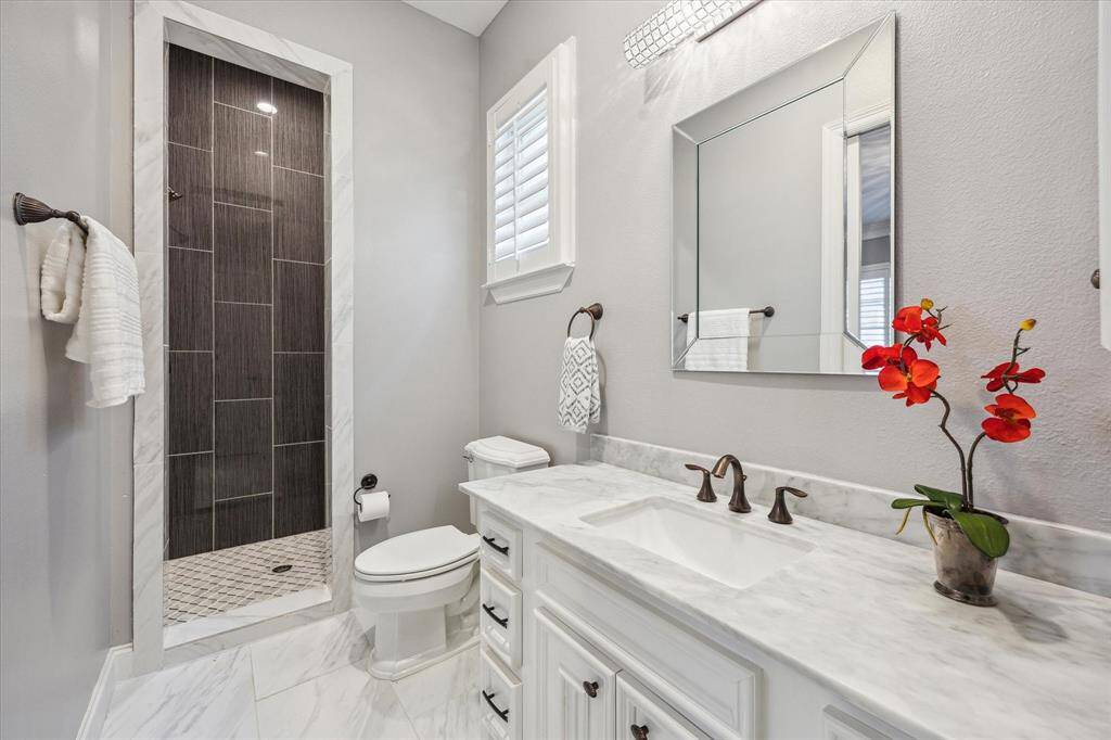 The large fenced-in backyard provides plenty of space to play, relax, or entertain, and includes convenient access to the second-floor balcony.