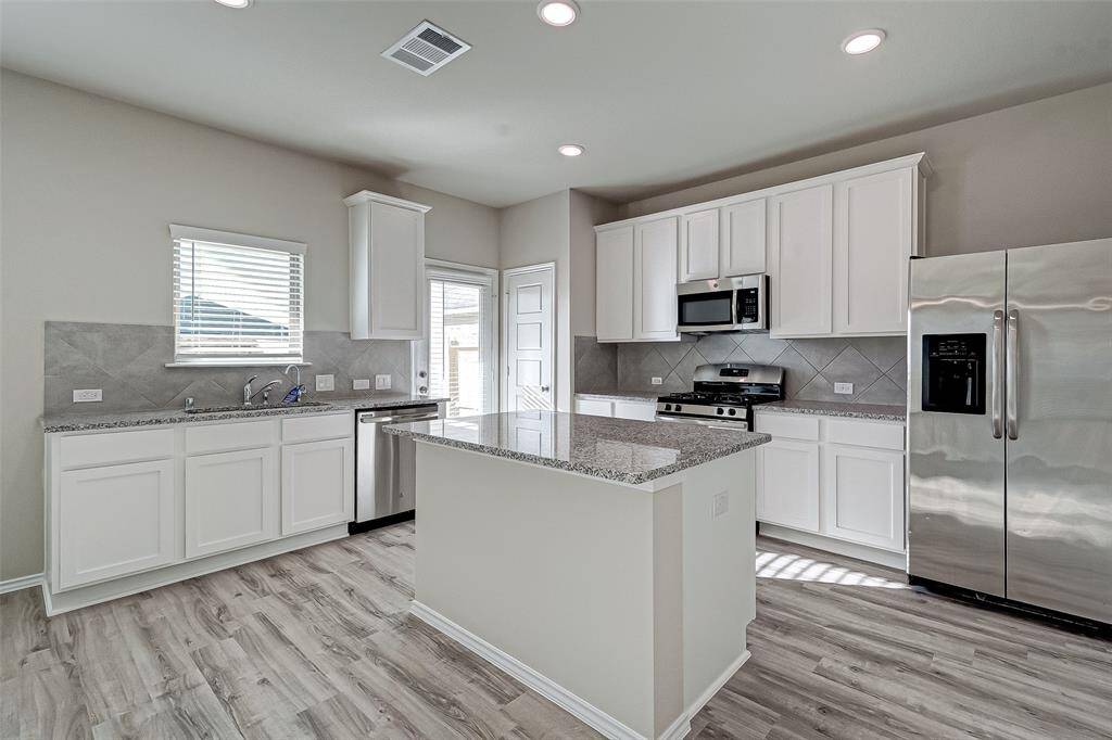 Stunning white cabinets, granite countertops and stainless steel appliances.