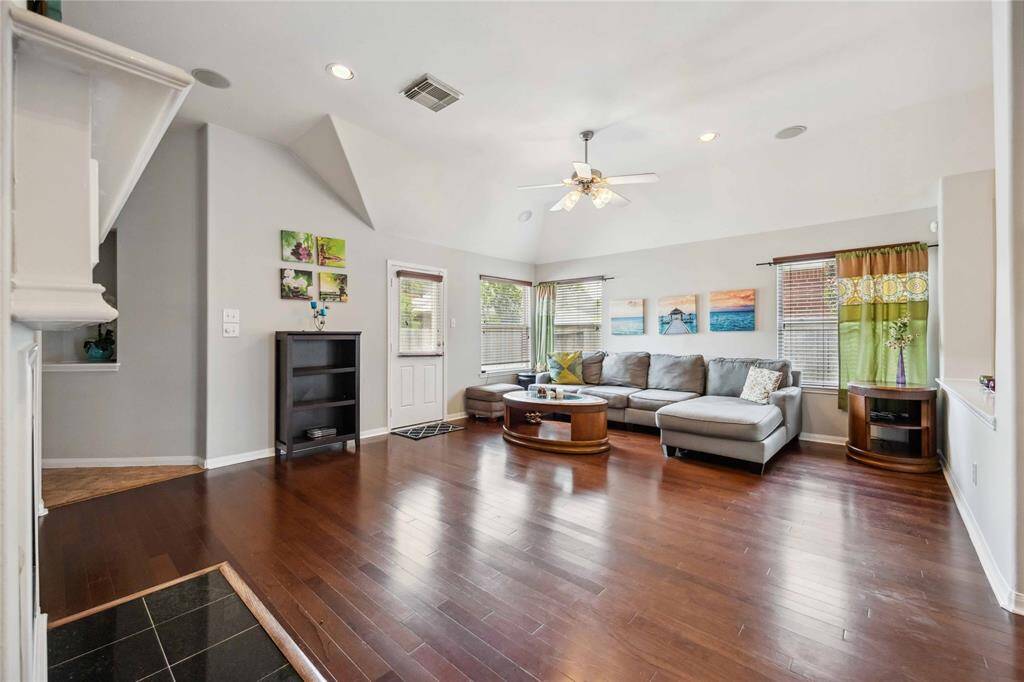 Spacious living room features a gas fireplace and open layout—ideal for relaxing or entertaining.