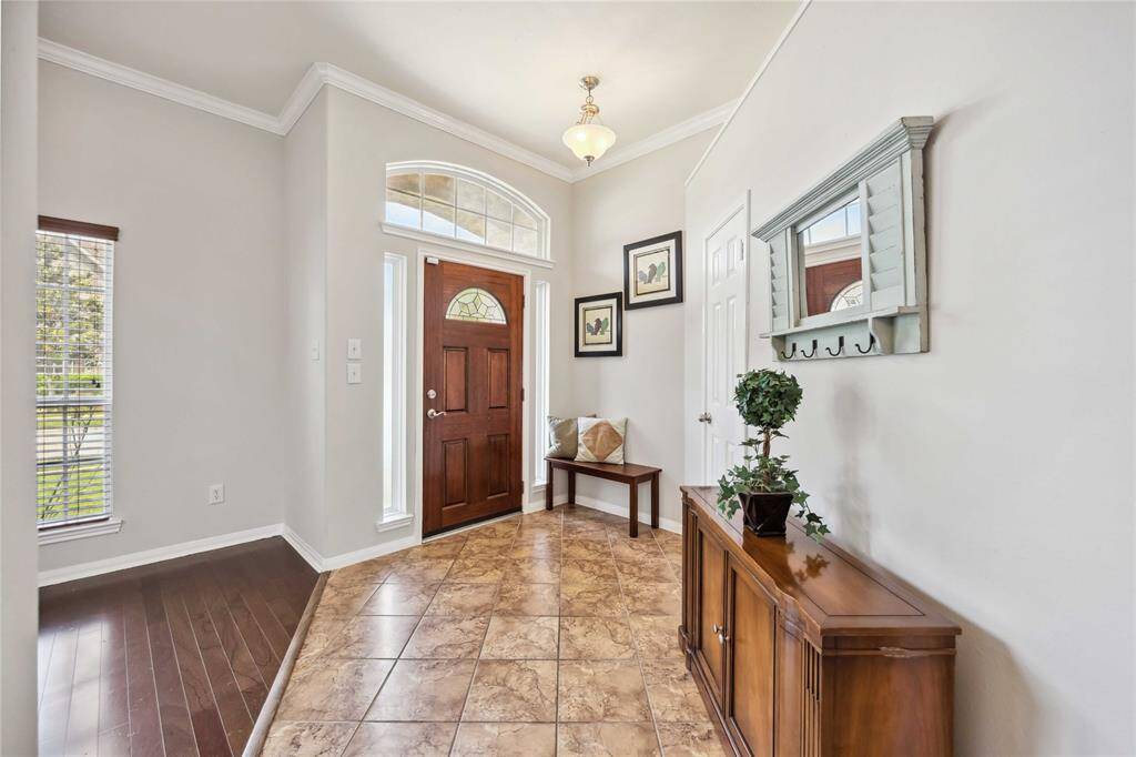 Step inside to a bright & open entryway with views into the formal living & dining areas—perfect for entertaining.