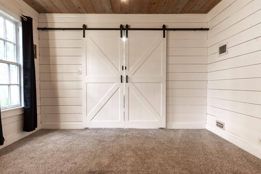 Barn doors leading to downstairs Primary Bedroom