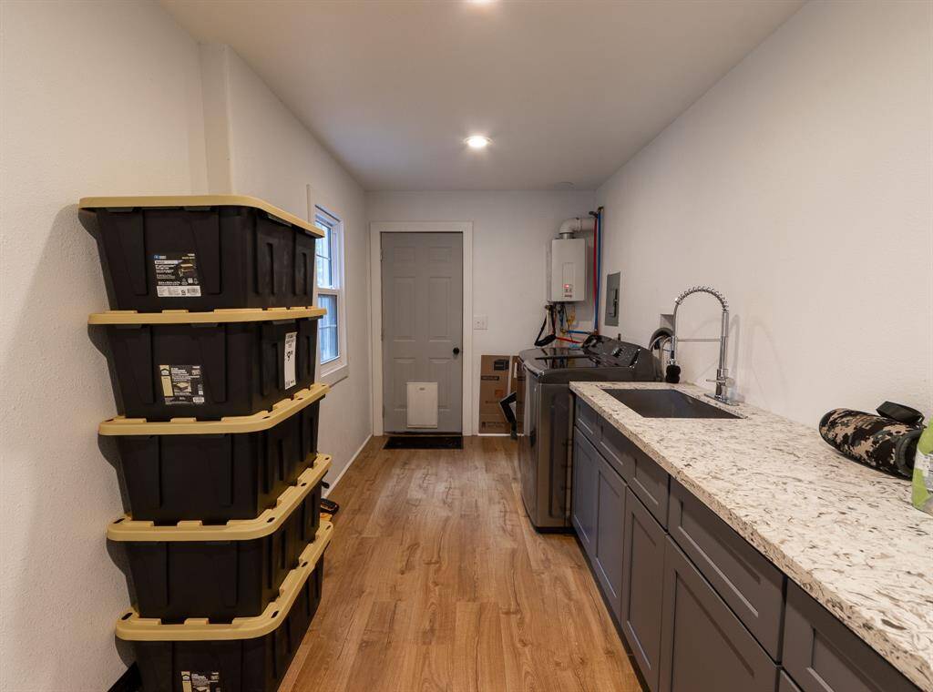 Laundry room with wash basin, tons of storage and garage access.
