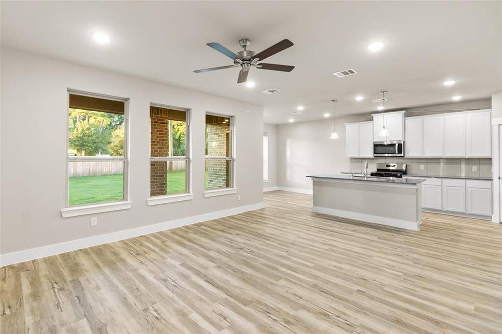Picture cozy gatherings in a living area that encourages laughter, while the sleek kitchen—equipped with state-of-the-art appliances—beckons culinary adventures and family dinners.