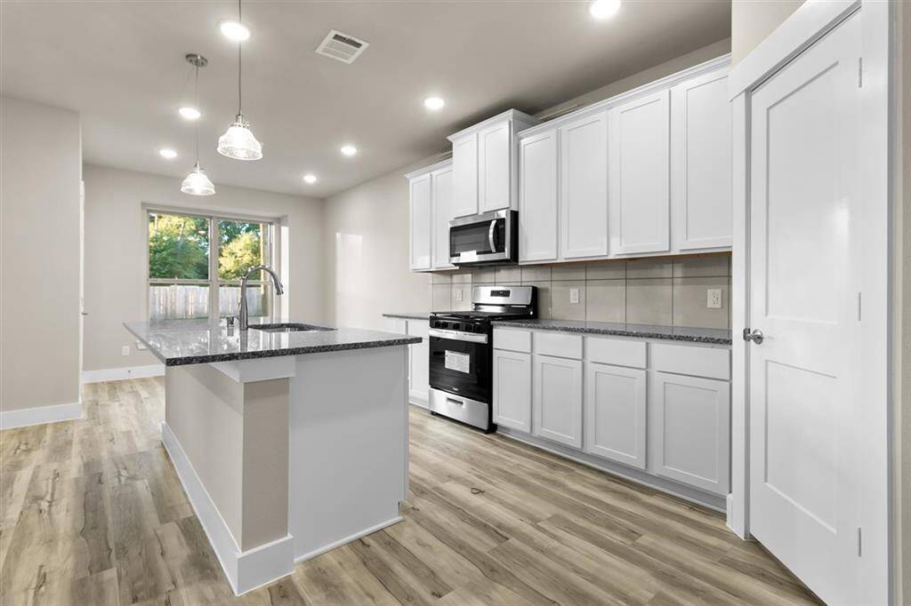 Natural light pours in through large windows, creating a bright and airy atmosphere that makes cooking feel less like a chore and more like a delightful experience.