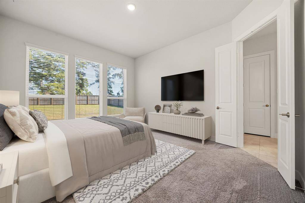 Come and unwind after a long day in this magnificent primary suite! This spacious room features plush carpet, warm paint, high ceilings, large windows with lots of natural light. *Virtually Staged