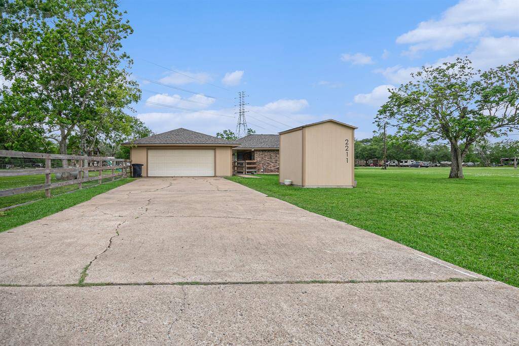 The current driveway with a detached garage, leads to the back door and patio.