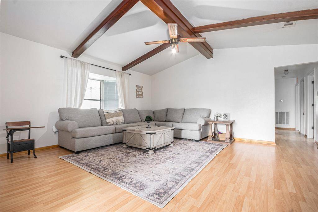 High ceilings in this living room with a view of the backyard.