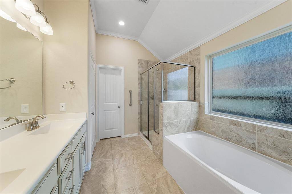 En suite bath is complete with double sinks, soaker tub and walk in shower.