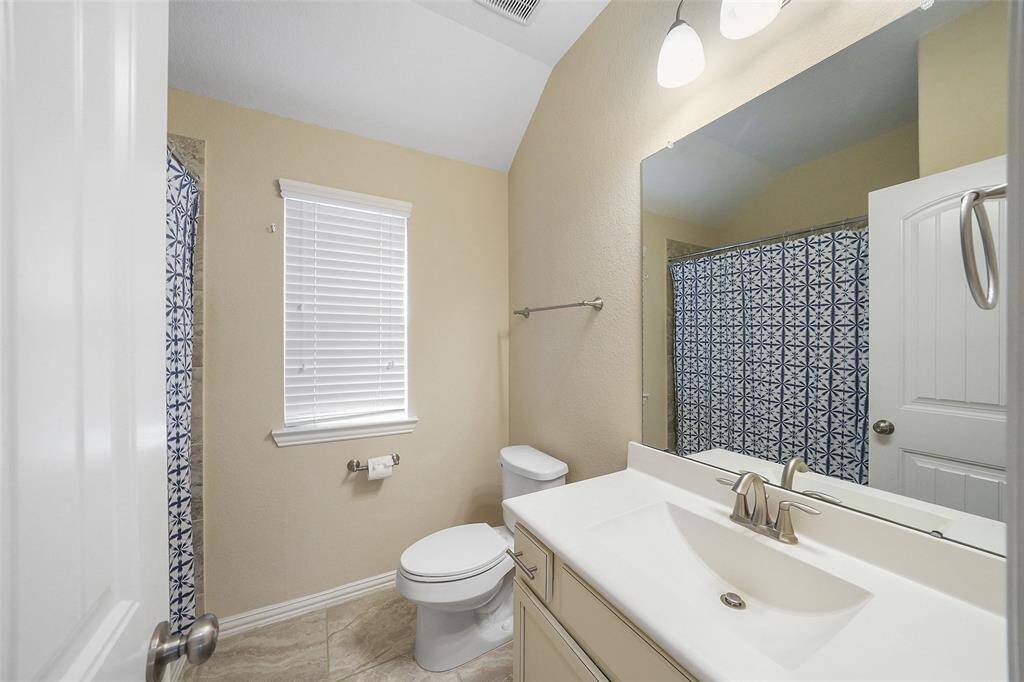 Secondary bath with shower/tub combo.