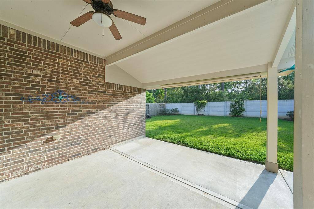 A view of your covered back patio looking out upon a green space, no rear neighbors!