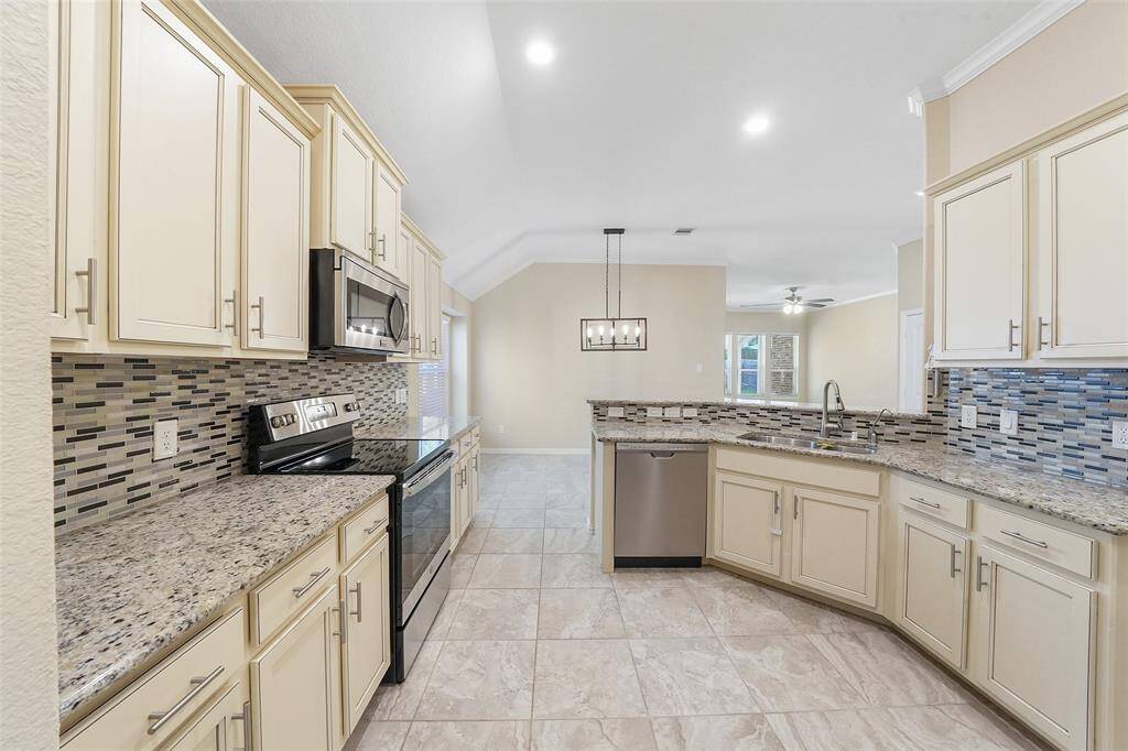 Granit counters and stainless appliances complete this kitchen.