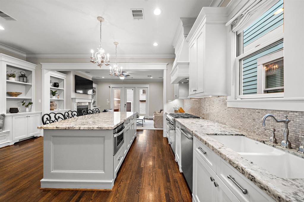 From the kitchen, enjoy a seamless view into the living room and out to the covered back porch—blending indoor and outdoor living perfectly.
