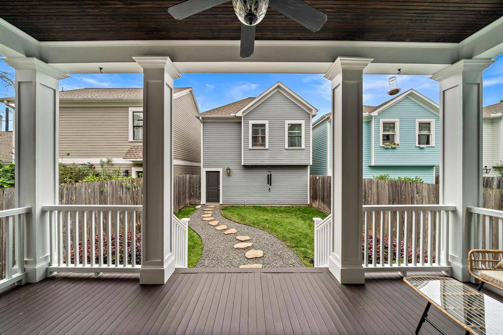 Step out to your covered patio, perfect for grilling and outdoor relaxation. Beyond, enjoy a view of the path to the garage and the built-out bonus room (466 sqft) above it—truly a gem!