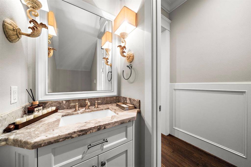 Before we head upstairs, let’s make a quick stop to check out the half bath! With its sleek countertops and beautiful light fixtures, it’s a charming touch to the first floor.