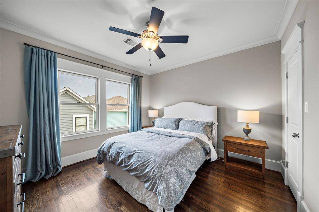 Third bedroom located on the second floor with hardwood floors, crown molding, ceiling fan and closet.