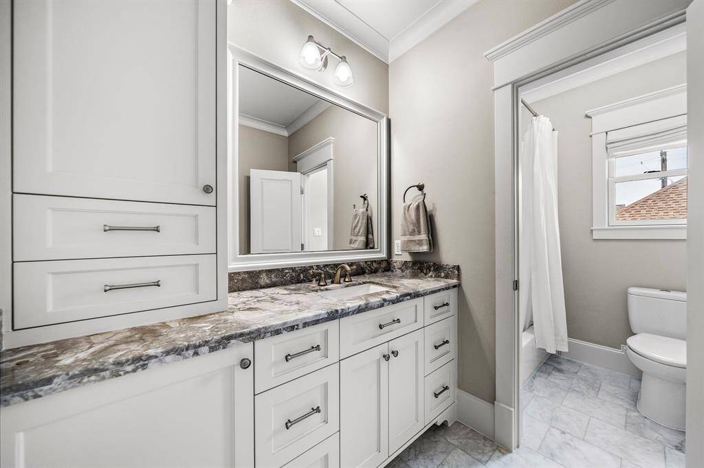 The second bathroom on the second floor features vibrant countertops, custom cabinets with plenty of storage space, and a convenient tub/shower combo—perfect for everyday use.