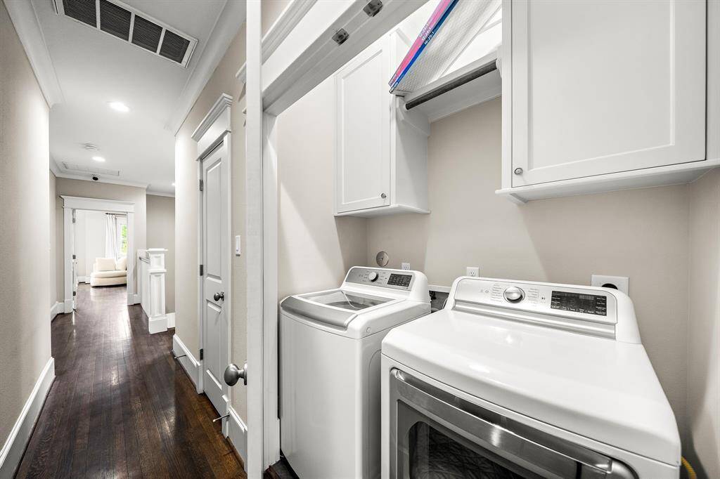 Utility room on 2nd floor with built-in cabinets for storage.