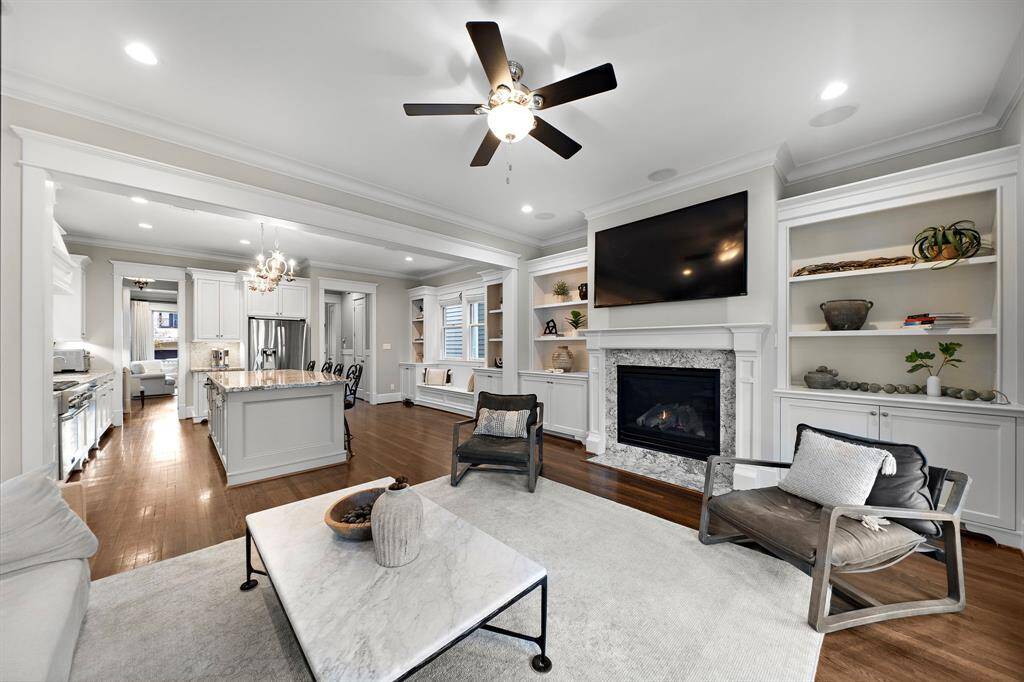 The living room, overlooking the kitchen, highlights the home's incredible design with tons of built-ins, stunning selections, and thoughtful details throughout. A true testament to quality, this home has been lovingly cared for by just one owner.