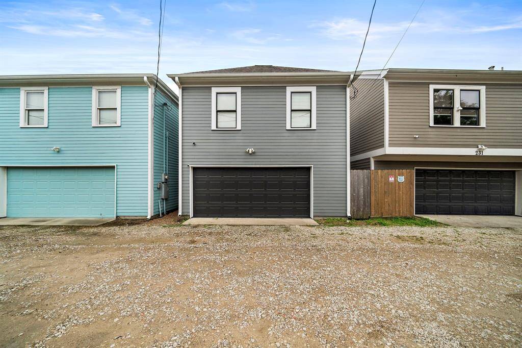 The two-car garage at the back of the home offers convenient access and plenty of space for parking and storage.