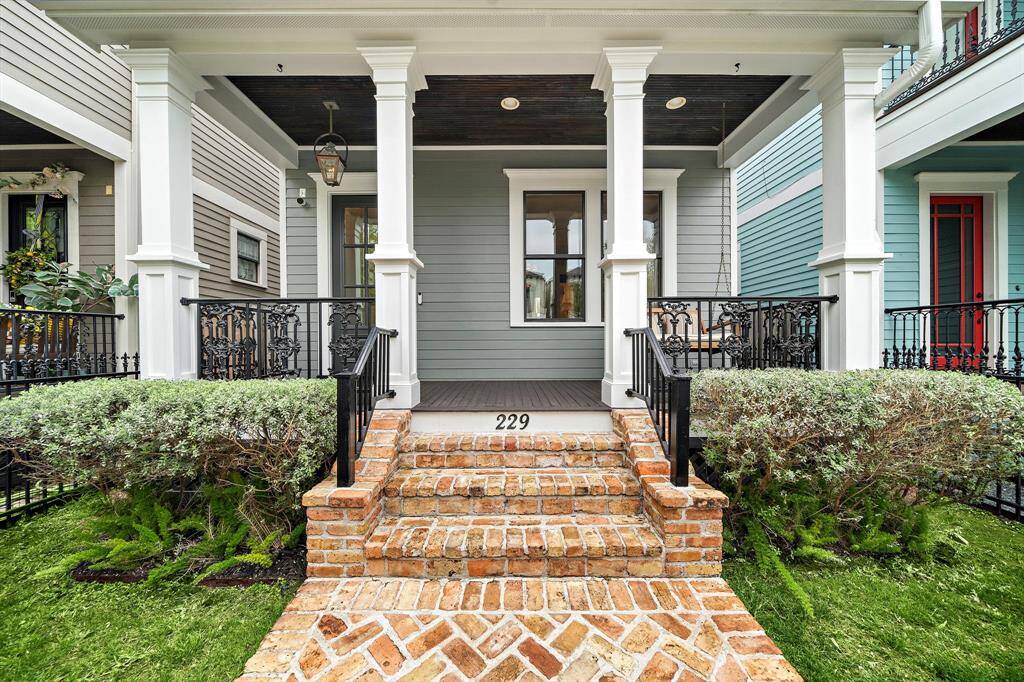 This entrance welcomes you with charm—brick stairs, a classic gas lantern, and a cozy porch swing perfect for unwinding. Come take a look!