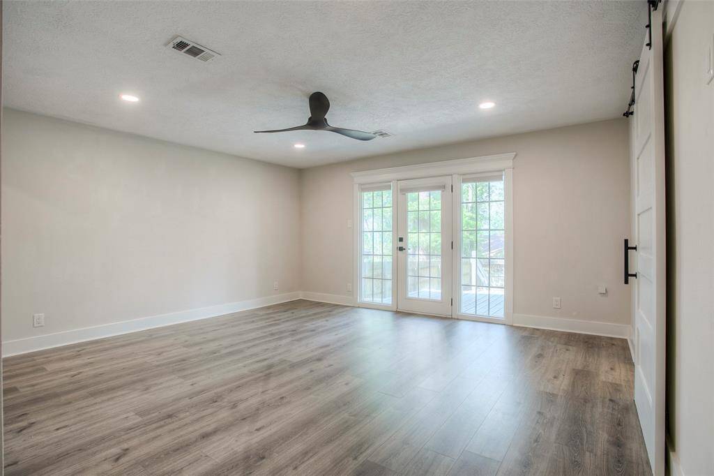 Primary bedroom with access to backyard and deck.