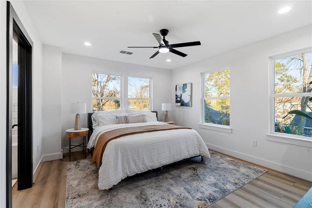 The primary bedroom is filled with natural light streaming through multiple windows, creating a bright and serene retreat. The spacious layout offers plenty of room to personalize and make your own.