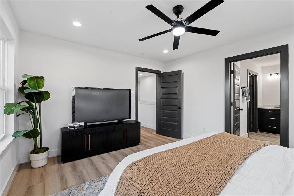 Bathed in natural light, this spacious primary bedroom offers a serene atmosphere, with ample wall space perfect for personal touches or additional furniture. The light pours in from the opposite side, creating a warm and inviting ambiance throughout the room.