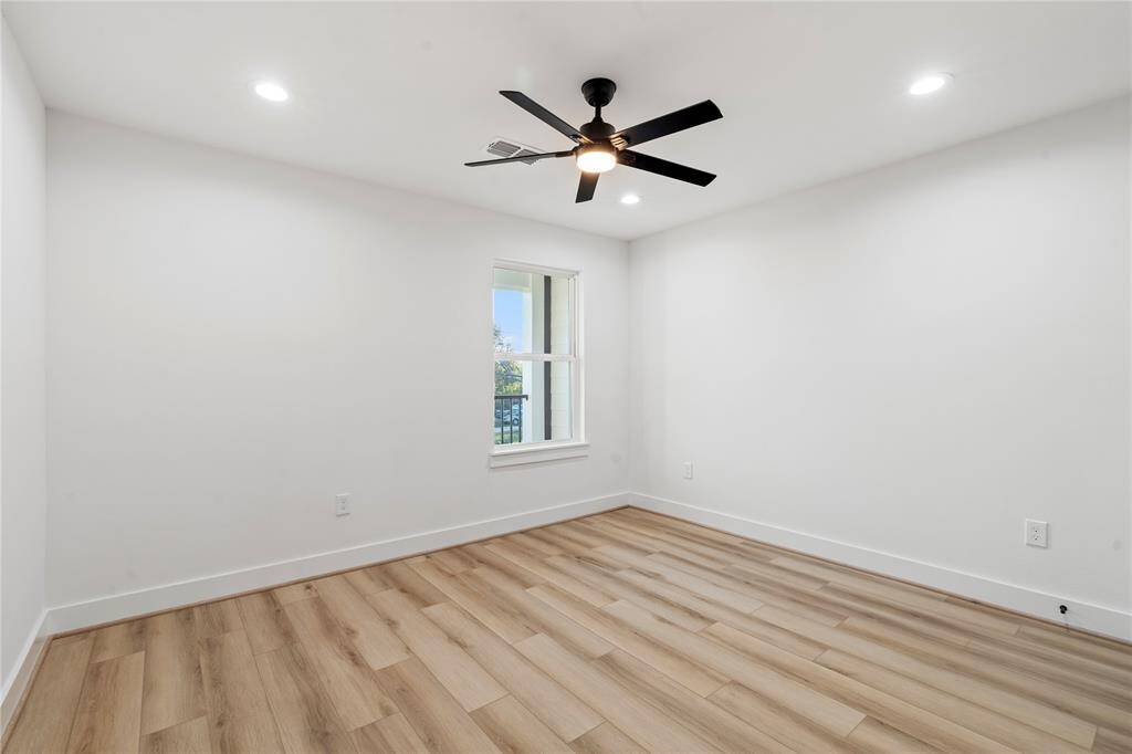 This spacious bedroom is filled with natural light from a large window, creating a bright and airy atmosphere. With plenty of room to personalize, it offers a versatile space for rest or relaxation.