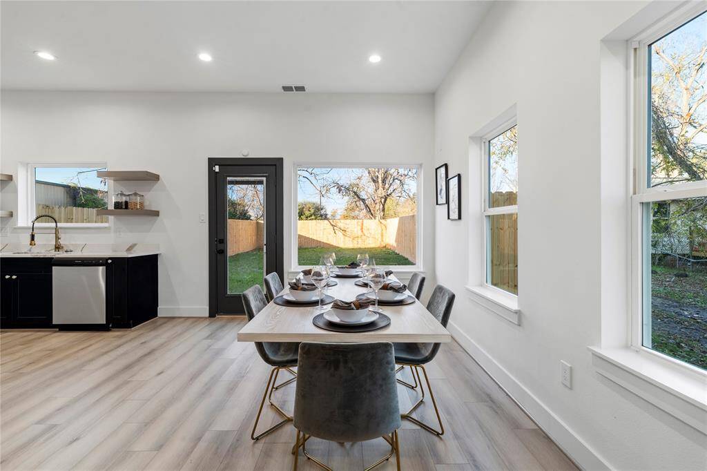 Natural light pours in, highlighting the modern design and seamless flow to the kitchen and outdoor areas—perfect for both relaxing and entertaining.