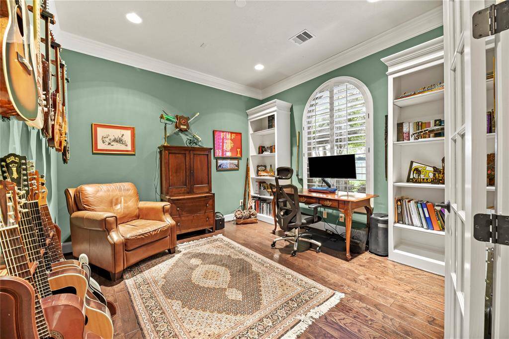 Private home office off the front entry with French doors and built-ins.