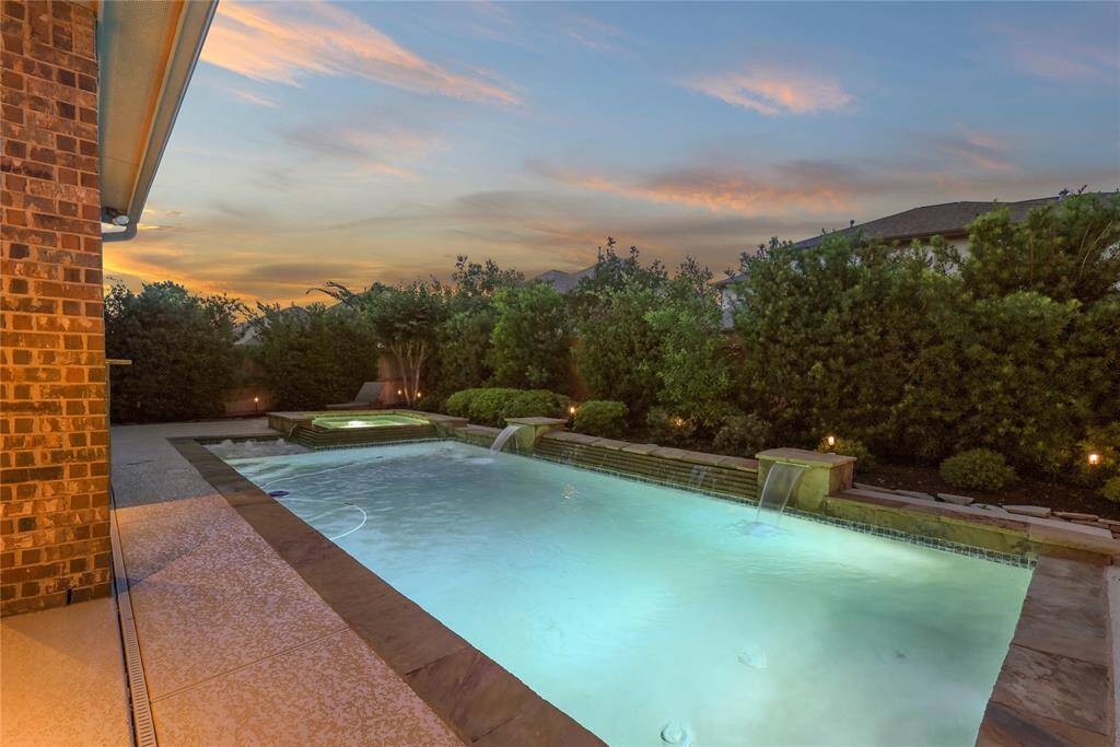 Heated swimming pool with waterfall and fountains.