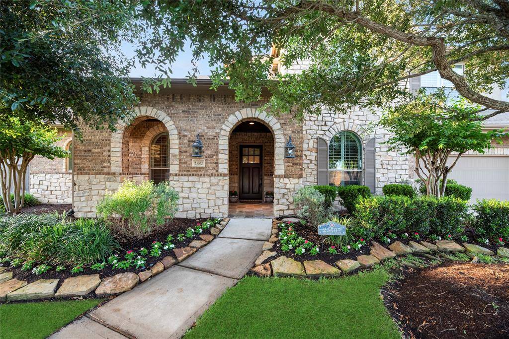 Brick/stone elevation and fresh landscaping create lovely curb appeal.