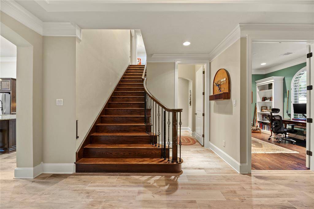 Wrought iron staircase with wood stairs.