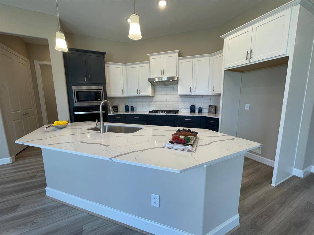 Experience Culinary excellence in the kitchen at Winfrey Estates, where state-of-the-art appliances meet sophisticatd design. This gormet space boasts expansive countertops, stylish cabinetry, and top-of-the-line fixtures, creating an ideal environment for both casual meals and lavish entertaining.