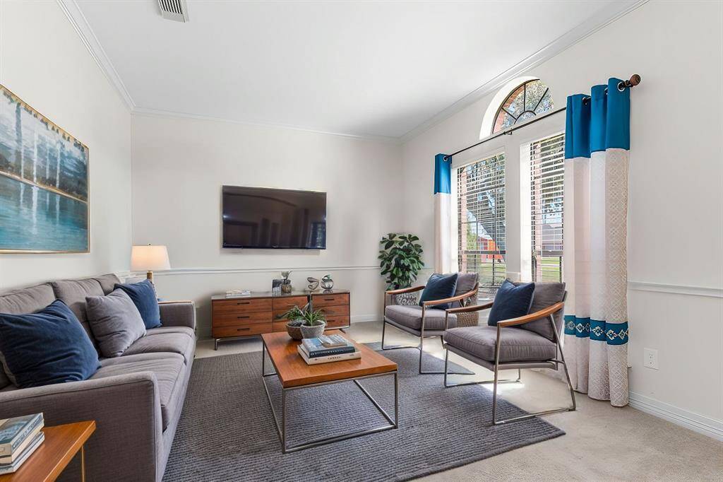 Formal living room has been virtually staged to illustrate the home's potential
