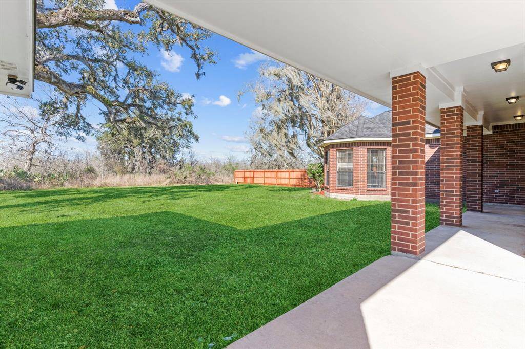 Large covered patio looks out to the sizedable back yard (big enough for a pool)
