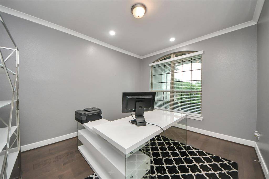 Transform your work routine into ahaven of productivity and comfort inthis thoughtfully designed homeoffice with crown molding and recessed lighting.