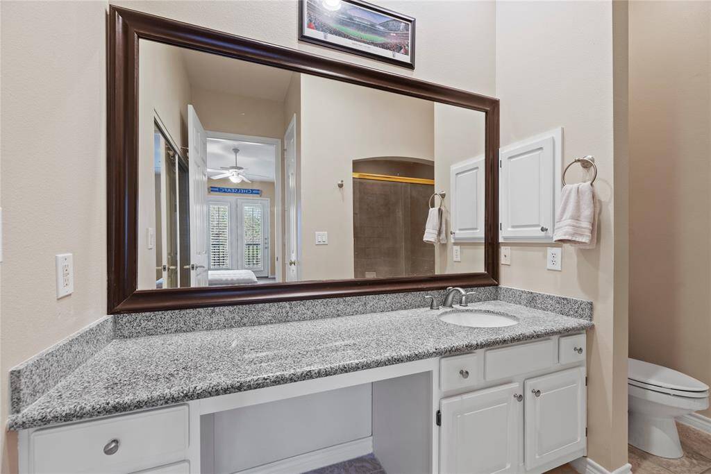 The primary bath with large vanity and plenty of cabinet and closet storage.
