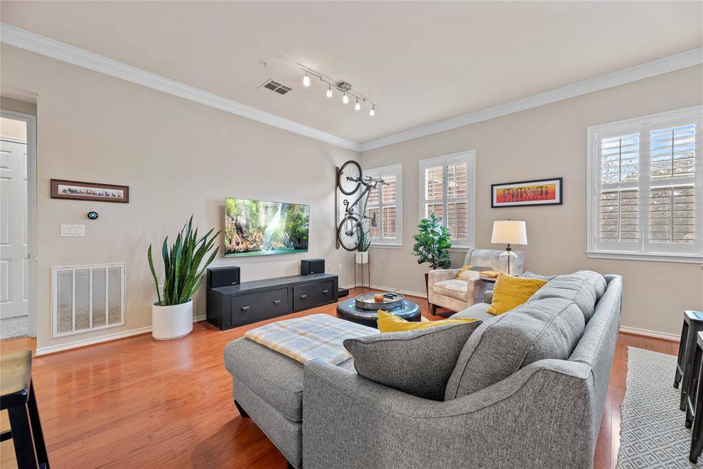 Welcome home to unit 206 of The 2400 McCue Condominiums. A chic living room space flooded with natural light is delightful! This large living area with a comfortable and inviting feel offers the perfect setting for relaxation and socializing.