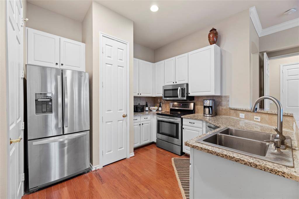 This kitchen boasts modern stainless-steel appliances, crisp white cabinets, a great breakfast bar, lots counter space along with cabinet storage. This space is going to make cooking fun!