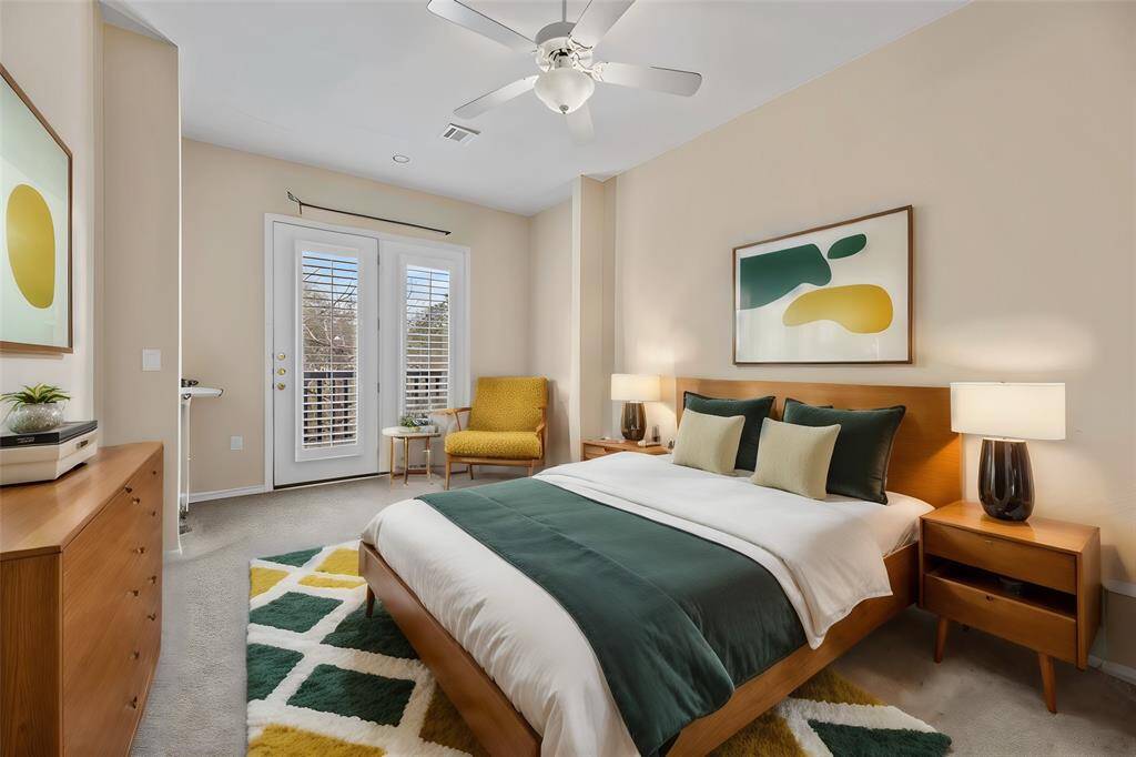Your primary suite with the sitting area overlooking the Juliet balcony letting all the natural light in through the French doors.