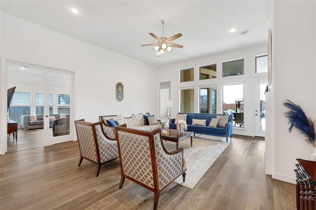 Enjoy this high ceiling living area, with a view of the custom built pool.
