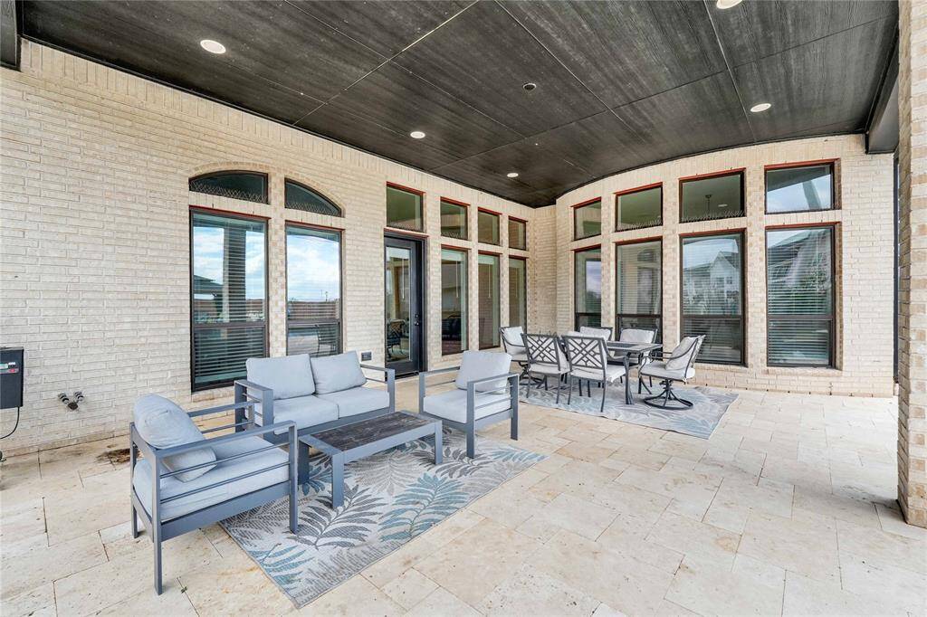 Specious covered patio with custom-built travertine floor.